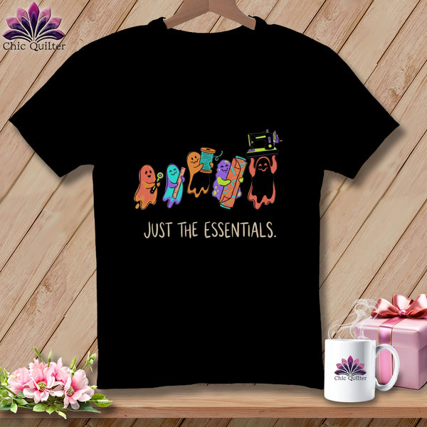 Black t-shirt with colorful ghosts holding sewing supplies and text "JUST THE ESSENTIALS."