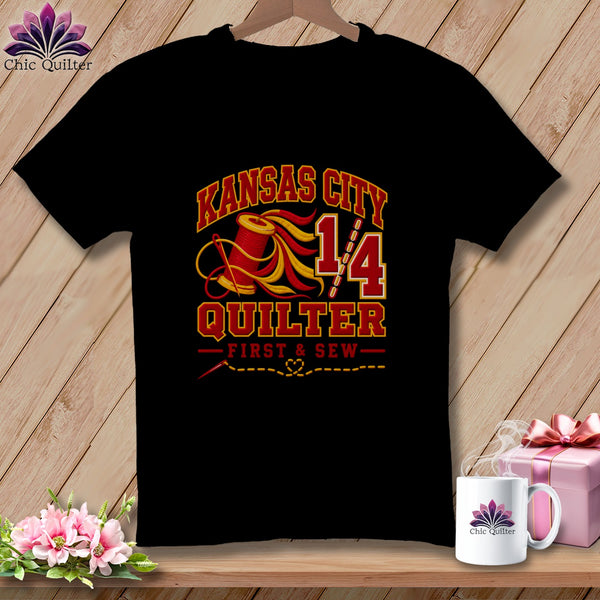 Black t-shirt displaying a Kansas City Quilter graphic with a spool of red and yellow thread.