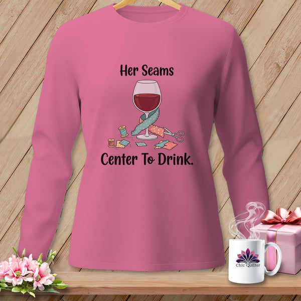Pink long-sleeve shirt with "Her Seams Center To Drink" text and sewing graphics.