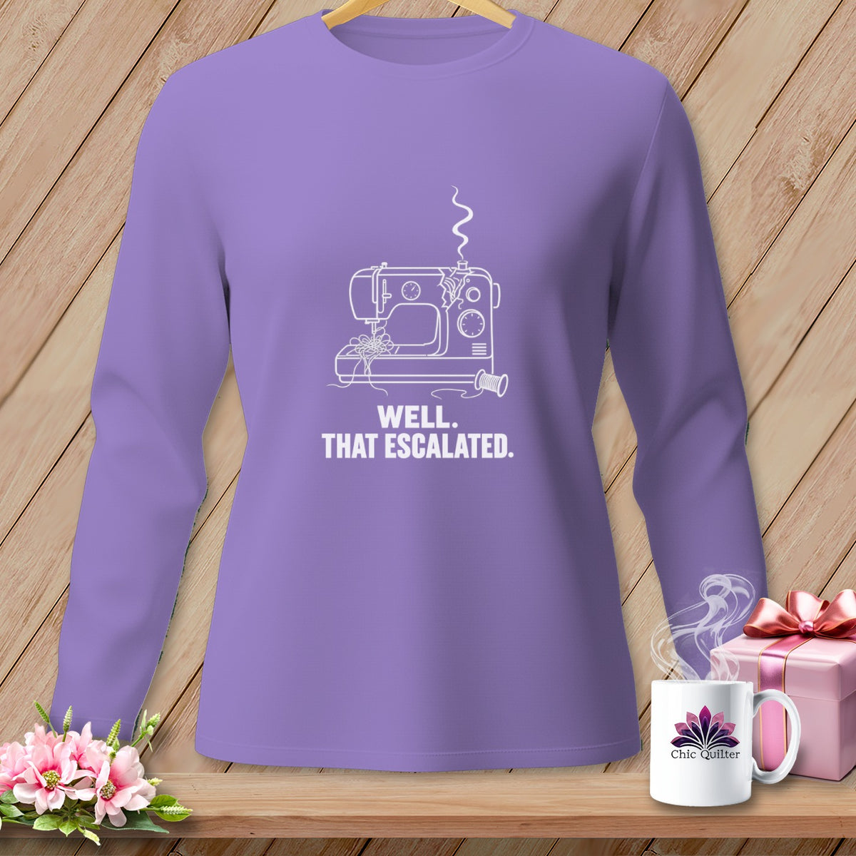 Purple long-sleeve shirt with a white line drawing of a sewing machine and the text "WELL. THAT ESCALATED."