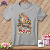 Gray t-shirt with an owl wearing glasses and a patchwork wing, holding a measuring tape.