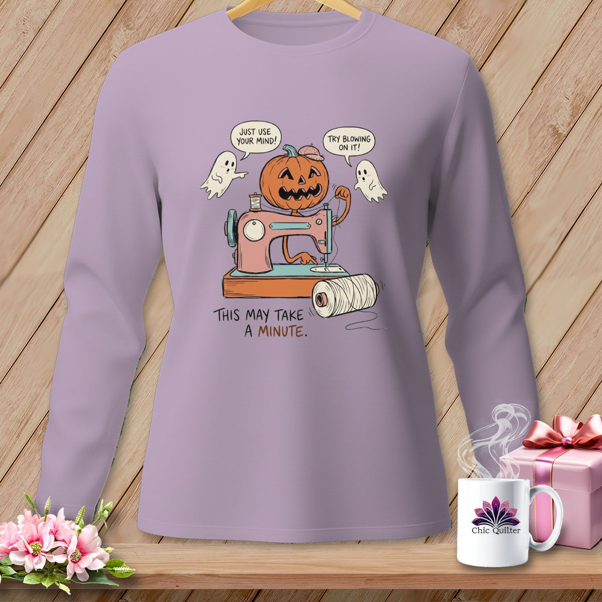 Halloween pumpkin using a sewing machine with ghosts and text "This May Take A Minute."