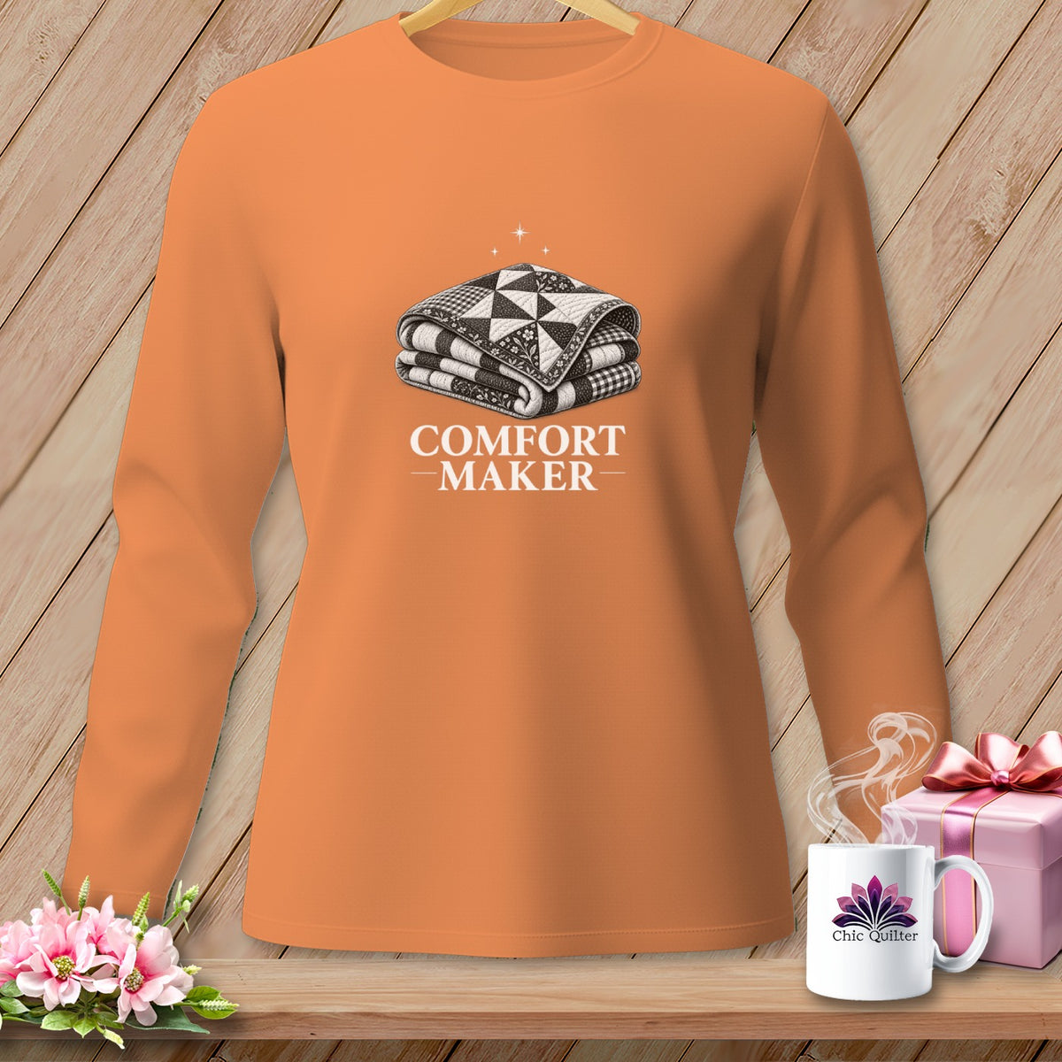 Orange long-sleeve shirt with "COMFORT MAKER" text and a folded quilt graphic.