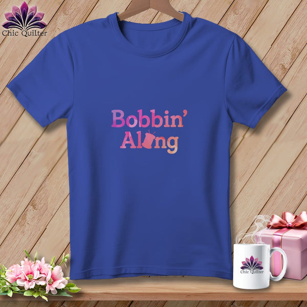 Blue t-shirt with "Bobbin' Along" text and a sewing bobbin graphic.