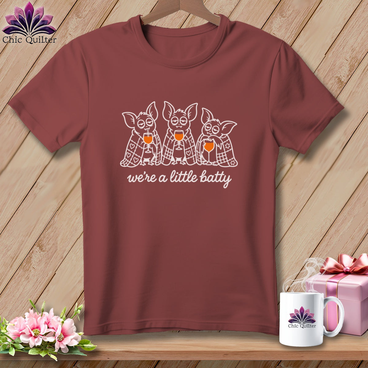 T-shirt with three cartoon bats holding wine glasses and text "we're a little batty."