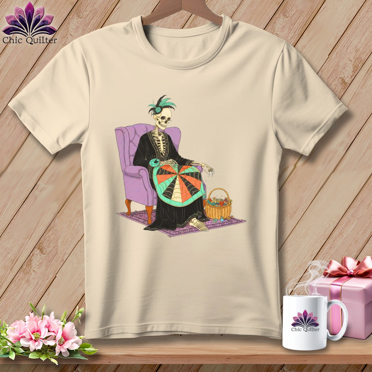 Skeleton quilter with yarn basket sits in purple chair, featured on cream t-shirt.