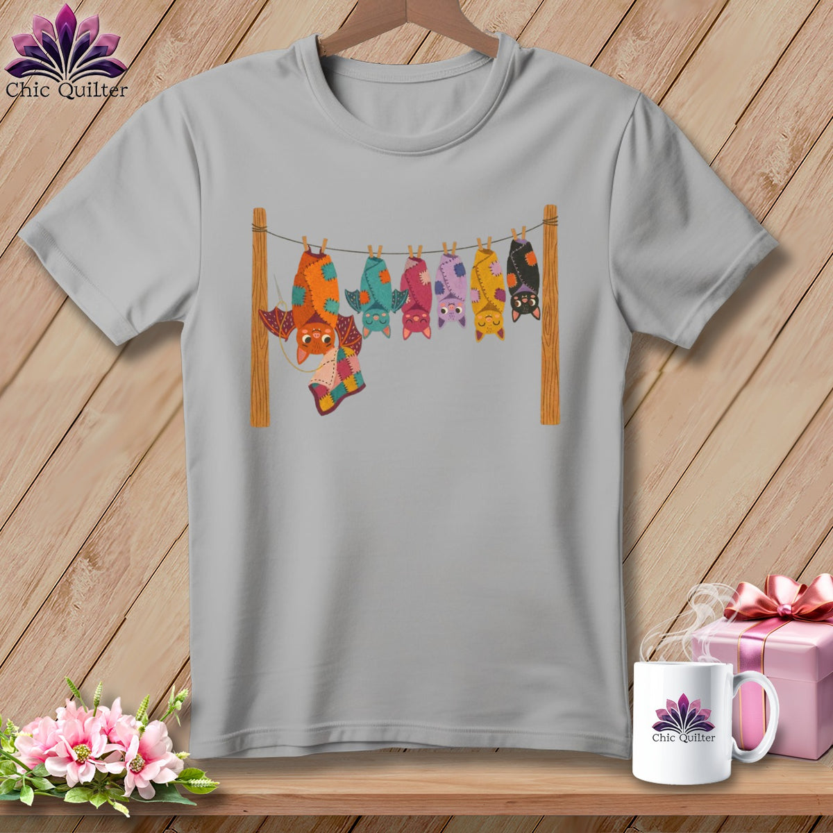 Grey t-shirt with colorful bats hanging on a clothesline.
