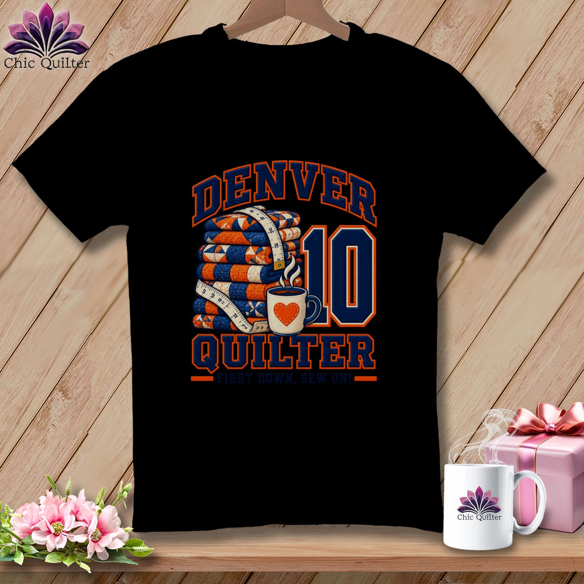 A black t-shirt features a graphic with stacked quilts, a coffee mug, and the text Denver Quilter, First Down, Sew On!