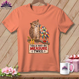 Peach t-shirt with owl wearing glasses, holding quilt wing, and text 
