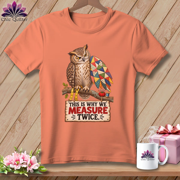 Peach t-shirt with owl wearing glasses, holding quilt wing, and text "This is why we measure twice".