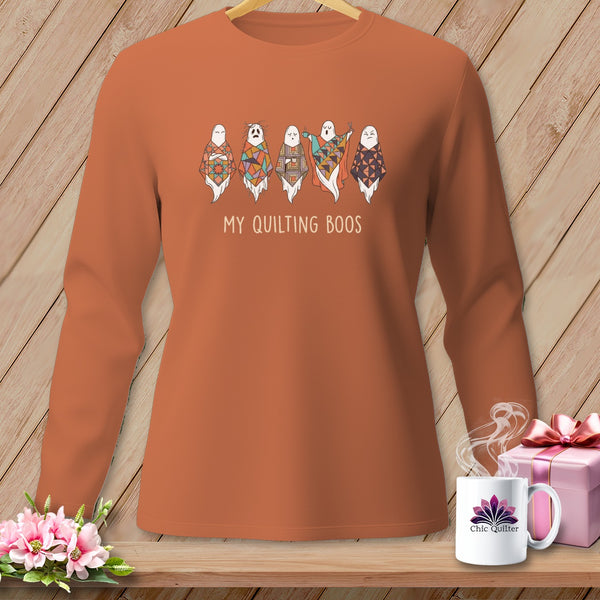 Orange long-sleeve shirt with ghosts wearing quilt squares and text "MY QUILTING BOOS".