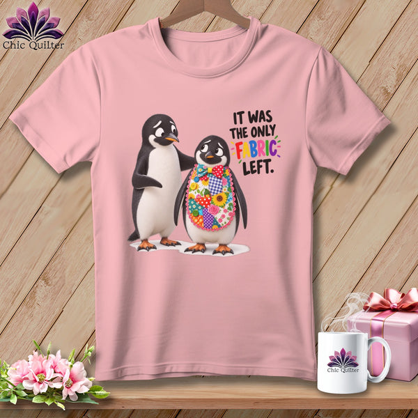 Pink t-shirt with two penguins, one wearing a colorful fabric bib. Text says "IT WAS THE ONLY FABRIC LEFT."