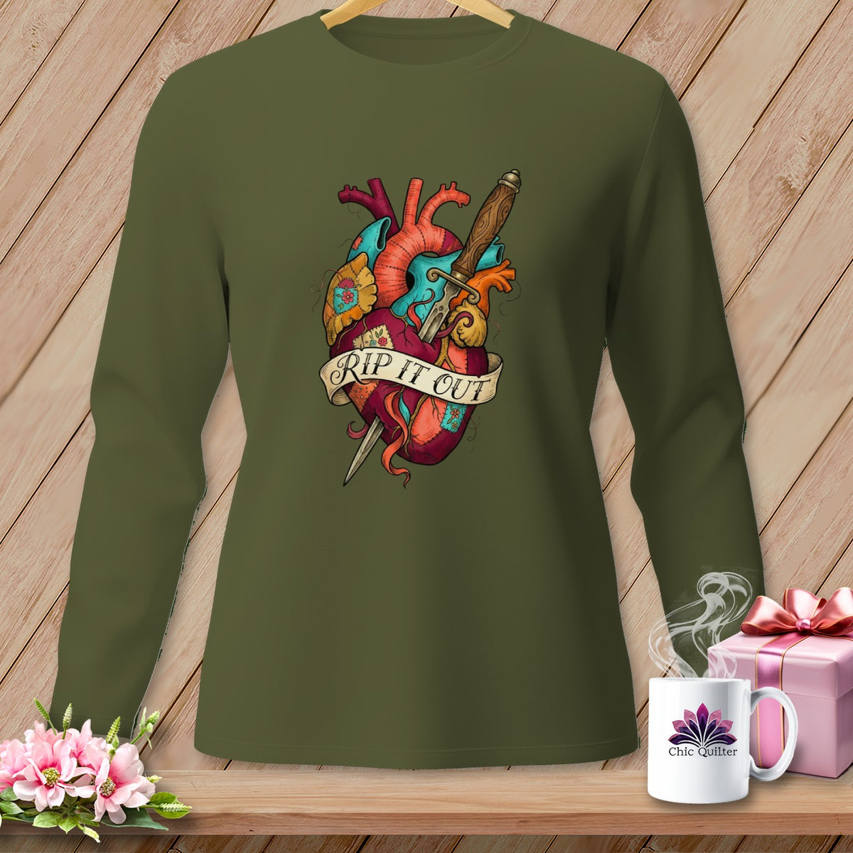 Green long-sleeve shirt with anatomical heart and dagger graphic that reads "RIP IT OUT".