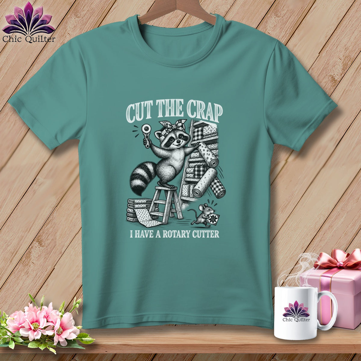 T-shirt graphic of a raccoon with a rotary cutter and fabric.