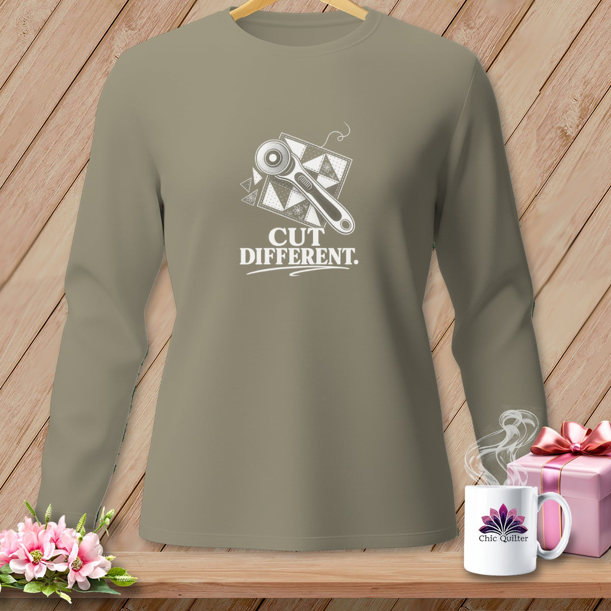 Long sleeve shirt with a graphic of a rotary cutter and fabric squares, reads "CUT DIFFERENT."