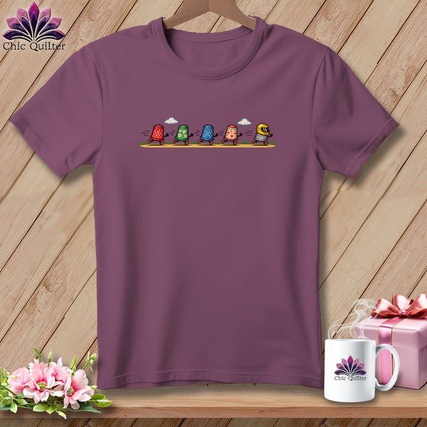 Plum crew neck t-shirt featuring a cartoon illustration of five racing thimbles on the chest.