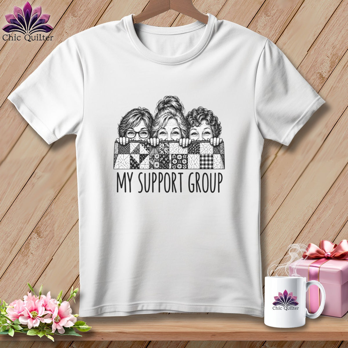 White t-shirt with black and white illustration of three women behind a quilt, text reads "MY SUPPORT GROUP".