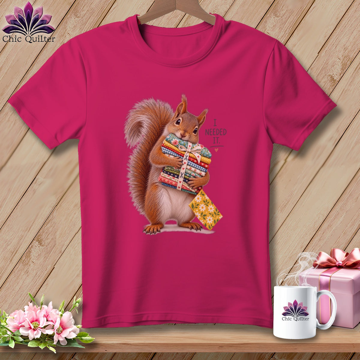 Fuchsia t-shirt with a squirrel holding colorful fabric stacks, text reads "I NEEDED IT."