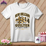 White t-shirt with a New Orleans Quilter graphic featuring a fleur-de-lis, numbers, and text.