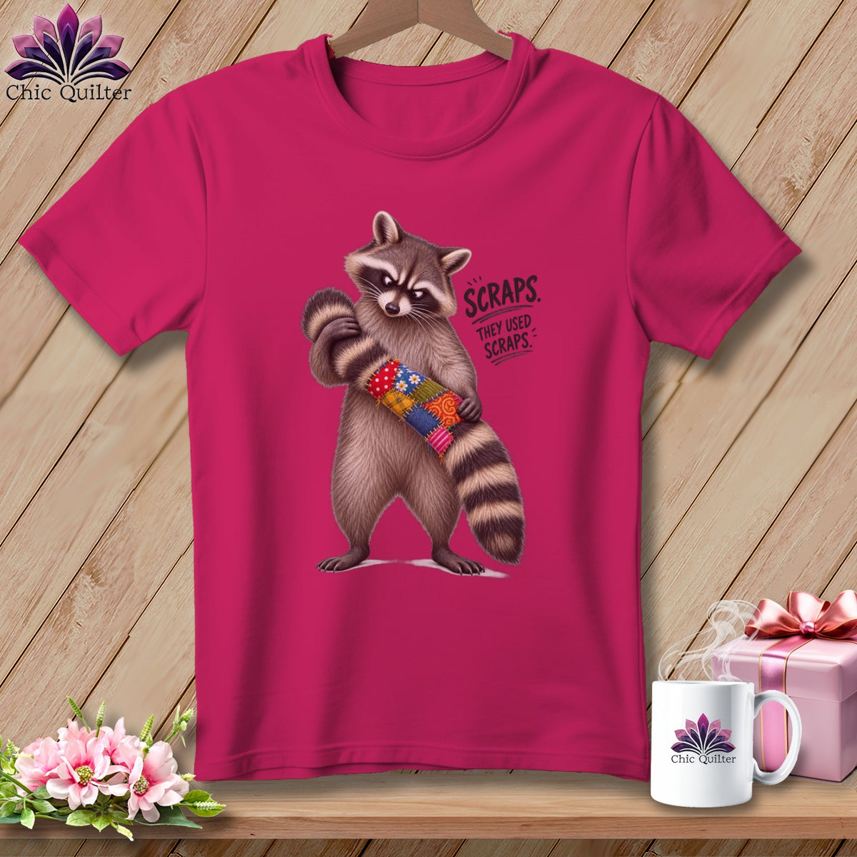 Raccoon holding a patchwork tube with text "SCRAPS. THEY USED SCRAPS."