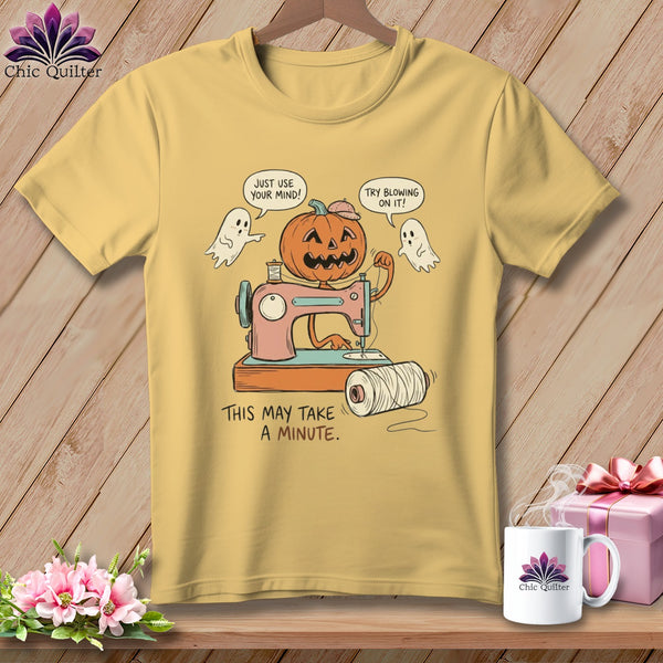 Yellow t-shirt graphic with pumpkin, ghosts, sewing machine, and text.