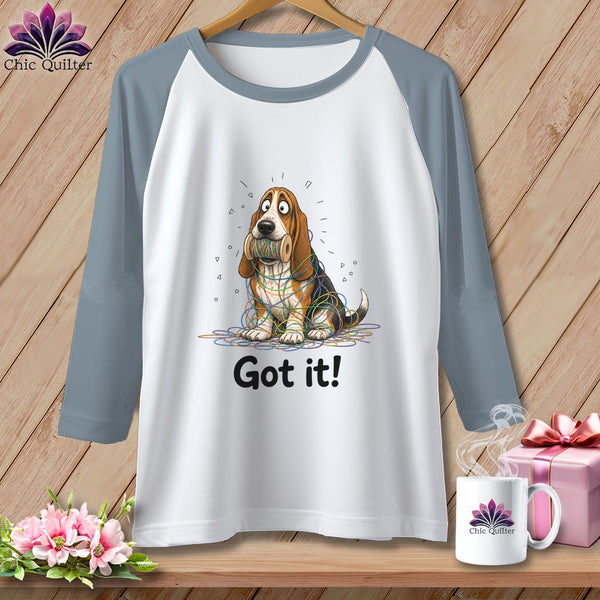 Raglan t-shirt with Basset Hound tangled in colorful thread and "Got it!" text.