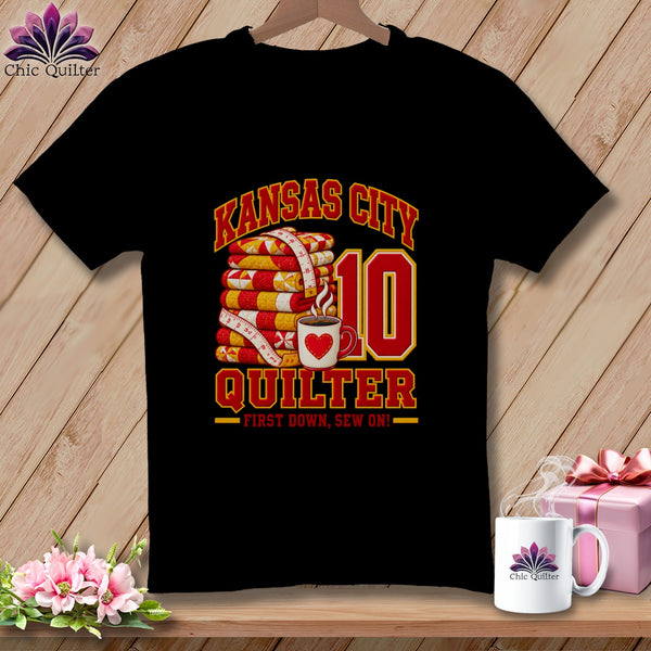 Black t-shirt featuring a Kansas City Quilter design with stacked quilts, a coffee mug, and the number 10.