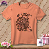 Peach t-shirt with a vintage-style black illustration of a peacock, a small bird, and the text OH PLUCK OFF.