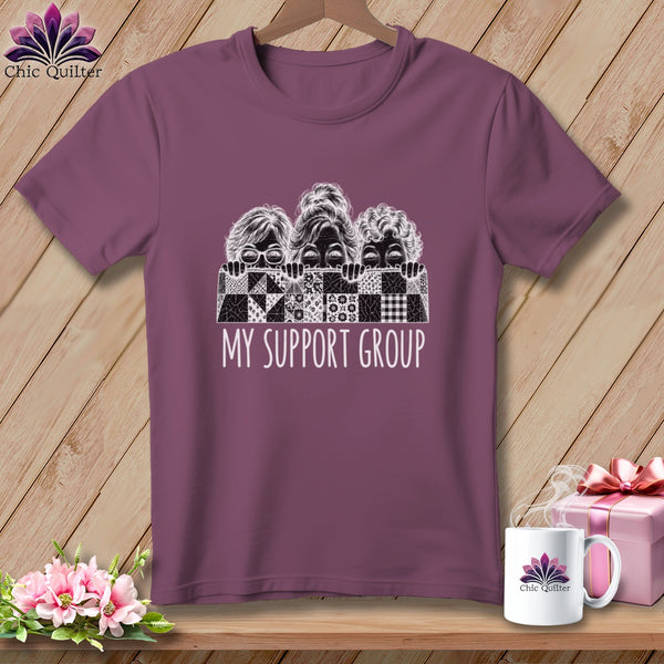 T-shirt with three women peeking over a quilt pattern, text "My Support Group".