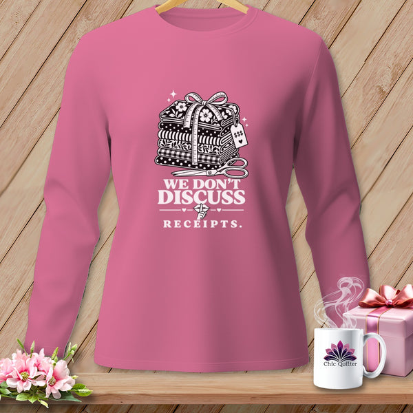 Pink long sleeve shirt with stacked fabric, scissors, and text.