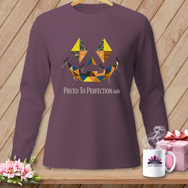 Purple long-sleeve shirt with a quilted jack-o'-lantern face and text "Pieced To Perfection-ish".