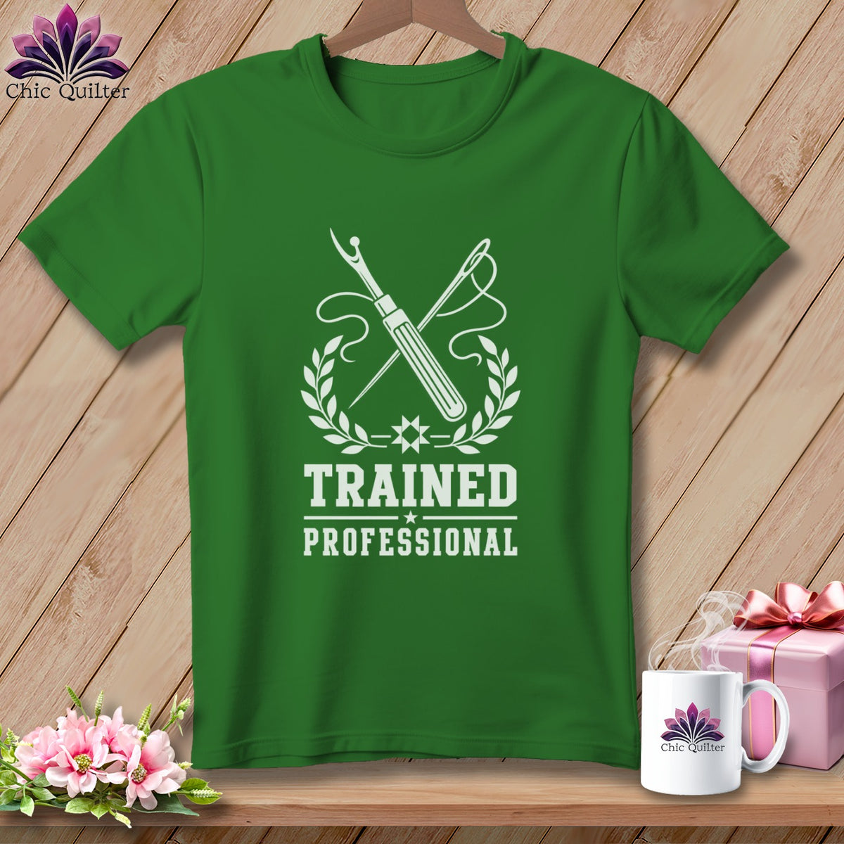 Green t-shirt with "Trained Professional" text and sewing tools graphic.