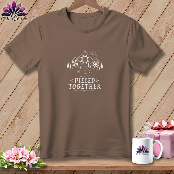Brown t-shirt with "Pieced Together" text and mountain quilt graphic.