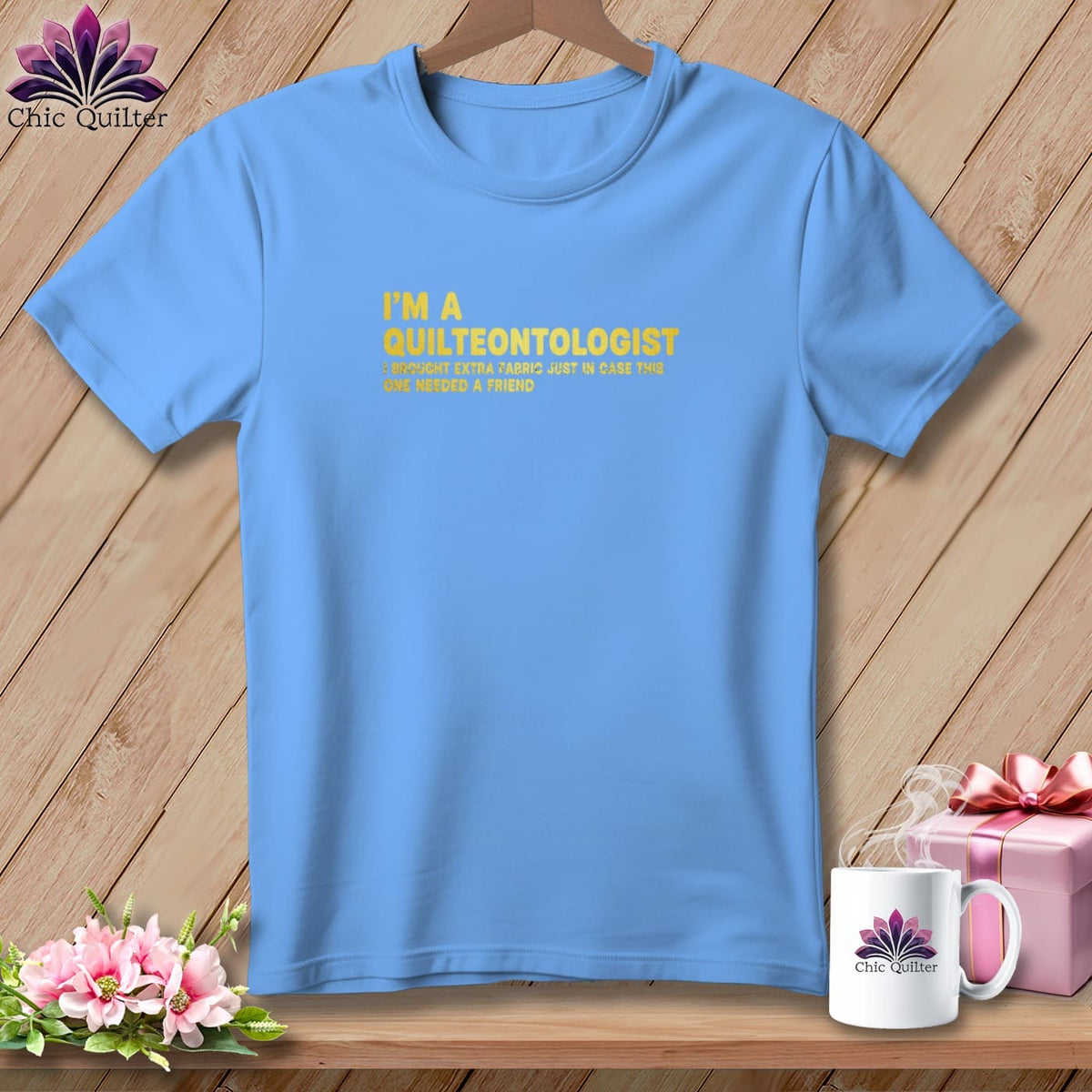 Light blue t-shirt with yellow text "I'M A QUILTEONTOLOGIST" and a humorous quote.