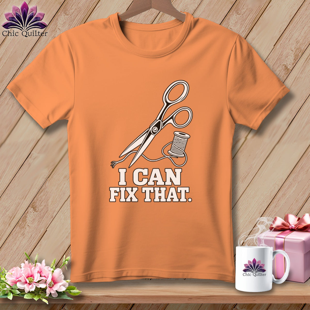 Orange t-shirt with scissors and thread graphic, reads "I CAN FIX THAT."