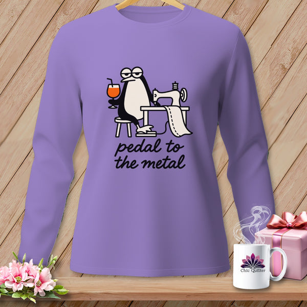 Purple long-sleeve shirt with cartoon penguin sewing and text "pedal to the metal."
