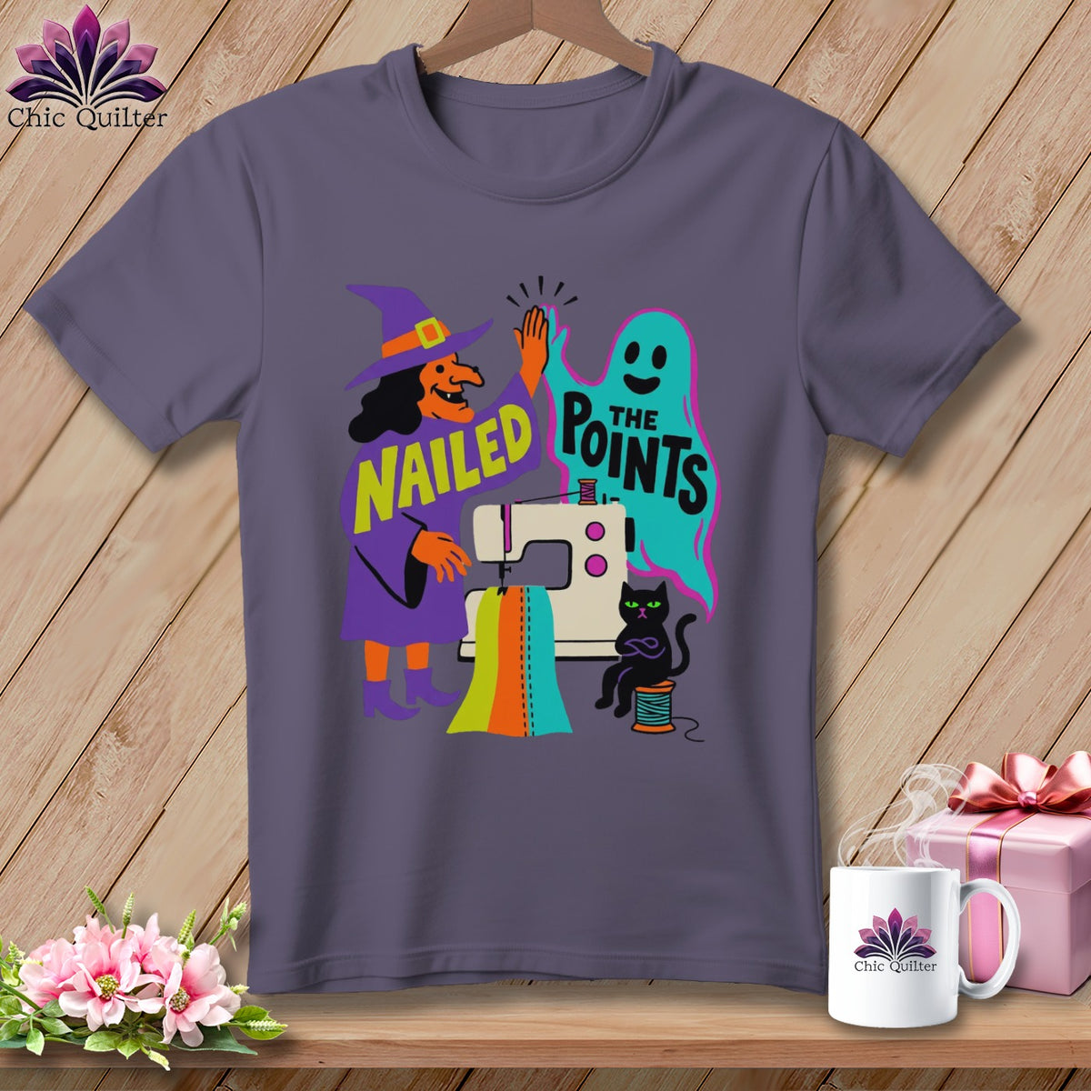 T-shirt with witch, ghost, cat, sewing machine, and text "NAILED THE POINTS".
