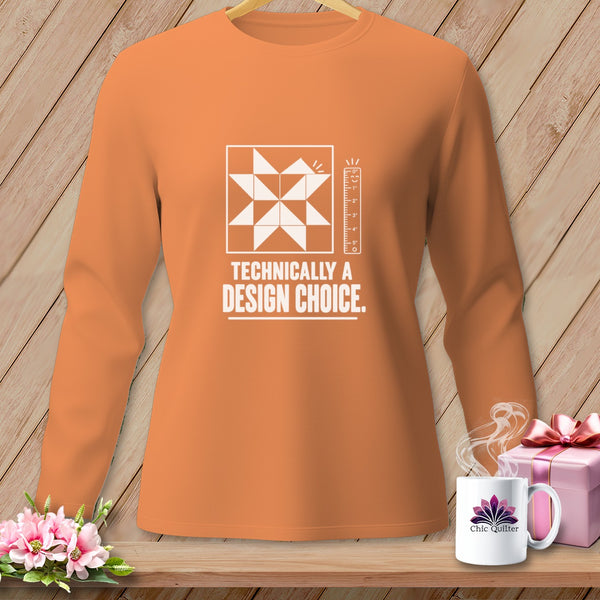 Orange long-sleeve shirt with a quilt block graphic and "Technically a Design Choice" text.