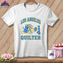 A white crewneck t-shirt featuring a blue and yellow graphic with text reading "Los Angeles Quilter".