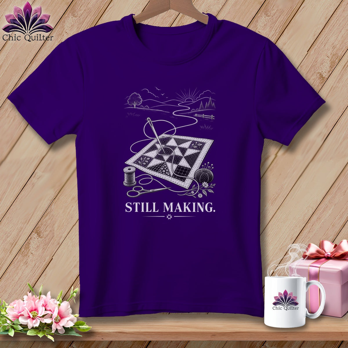 Purple t-shirt with quilt, needle, thread, scissors, and "STILL MAKING." text.