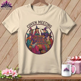 Witches in hats gathered around a table quilting, with 