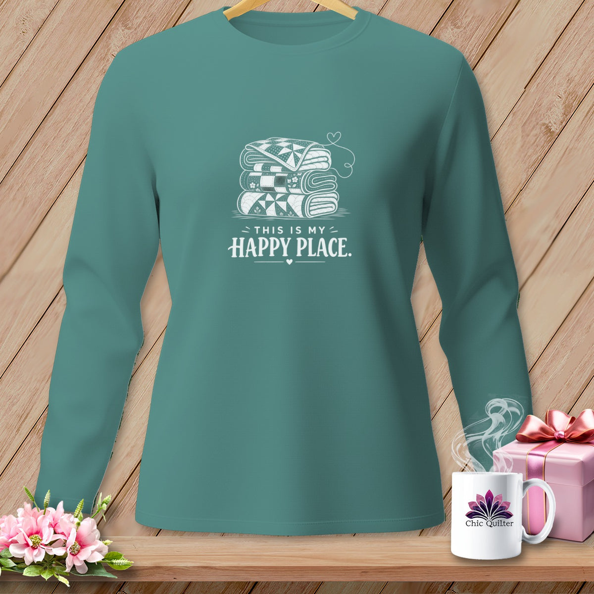 Teal long-sleeve shirt with stacked quilts graphic and "This is my happy place" text.