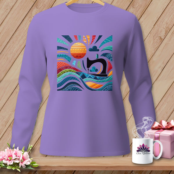 Purple long-sleeve shirt with a sun, sewing machine, and colorful quilted waves graphic.