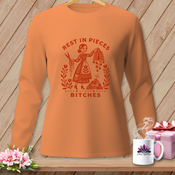 Orange long-sleeve shirt with "Rest in Pieces Bitches" text and a graphic.