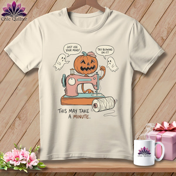 Jack-o'-lantern sewing machine with ghosts and text "This may take a minute."