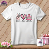 A white t-shirt hanging on a wooden background, featuring a pink graphic with the text Peace Love Fabric.