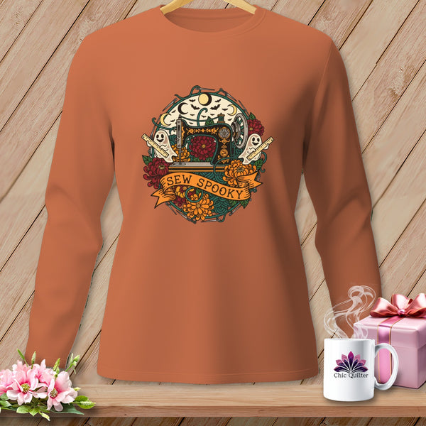 Long-sleeve shirt with Halloween sewing graphic featuring a sewing machine, ghosts, and "Sew Spooky" text.