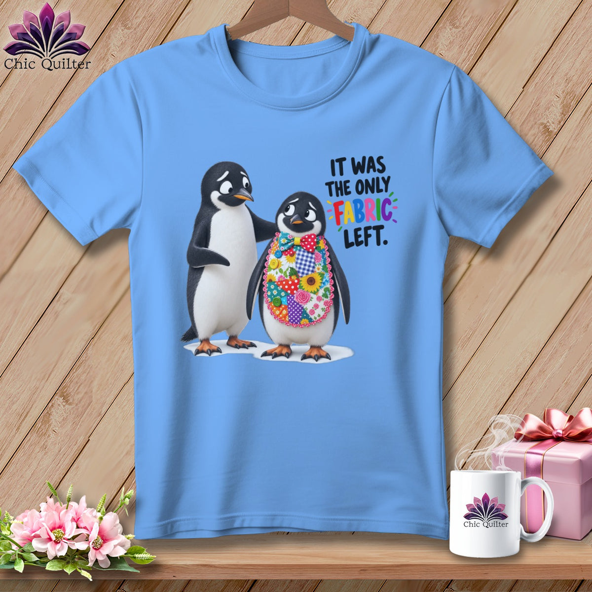 Light blue t-shirt with two penguins and text "IT WAS THE ONLY FABRIC LEFT."