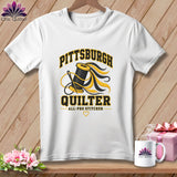 White t-shirt featuring a Pittsburgh Quilter graphic with a spool of thread, needle, and text.