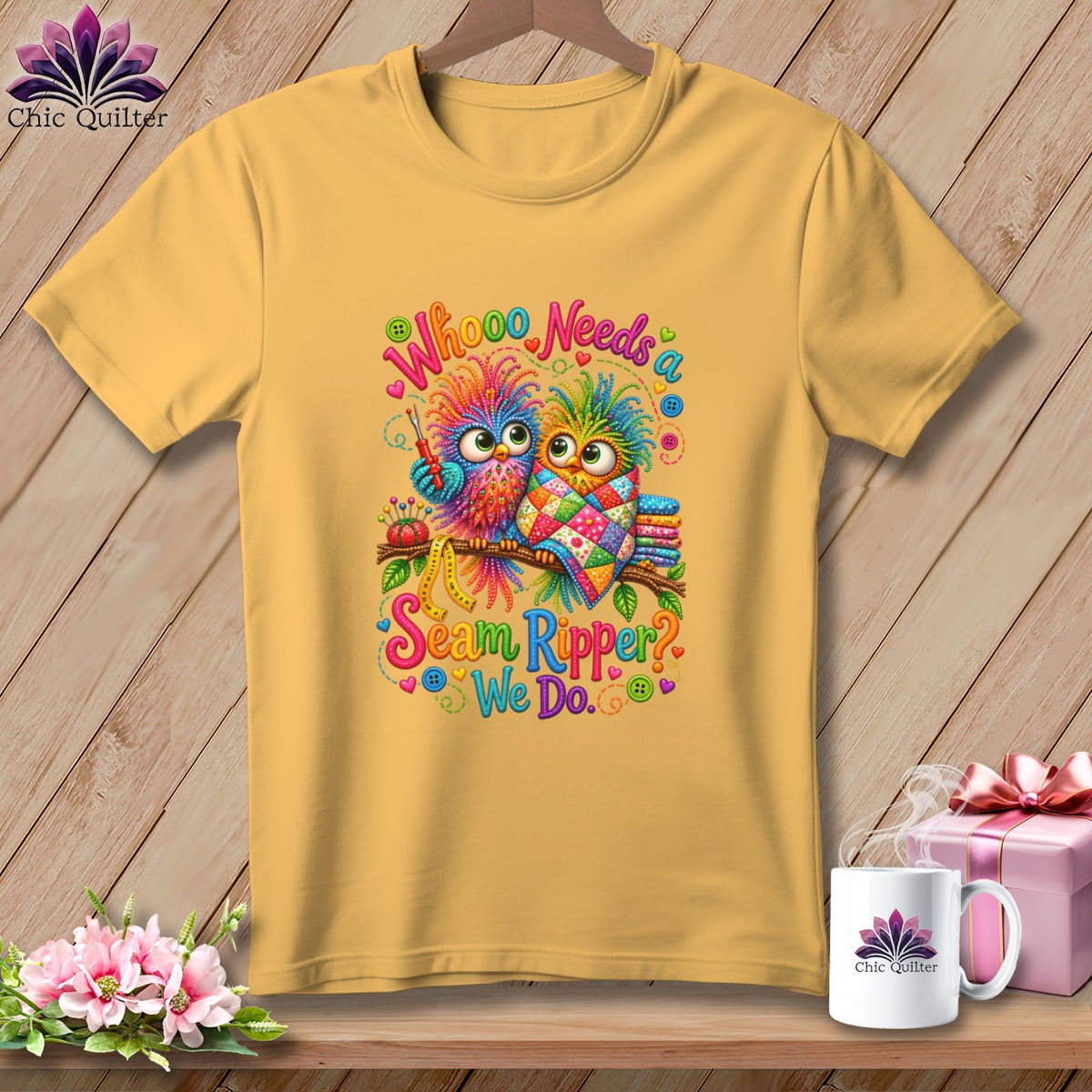 A yellow t-shirt hanging on a wooden background, featuring a colorful owl graphic with quilting text.